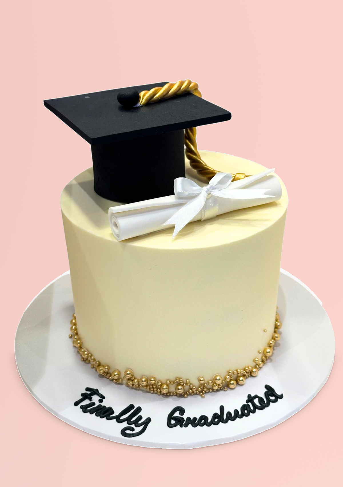 Graduation Cake with a mortarboard topper and a Finally Graduated plaque