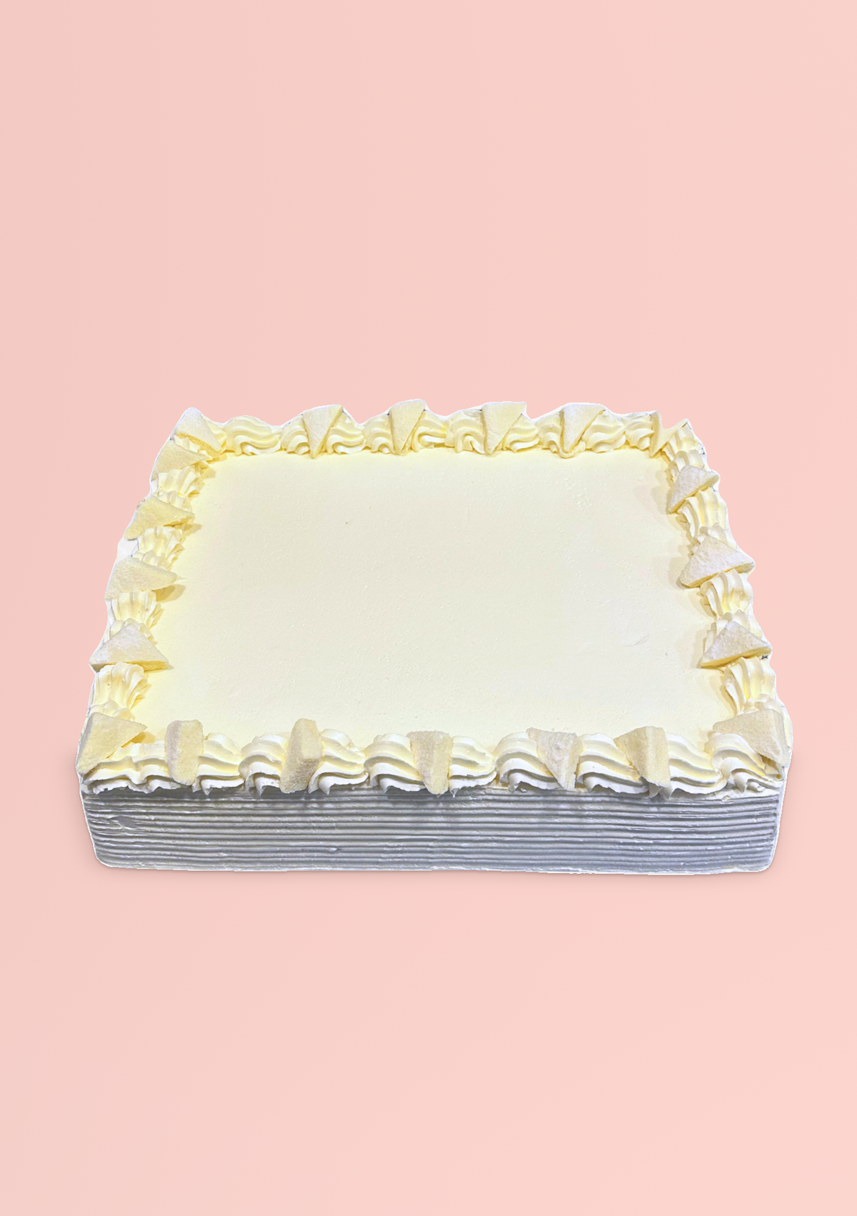 Rectangular white chiffon slab cake with a piped cream border
